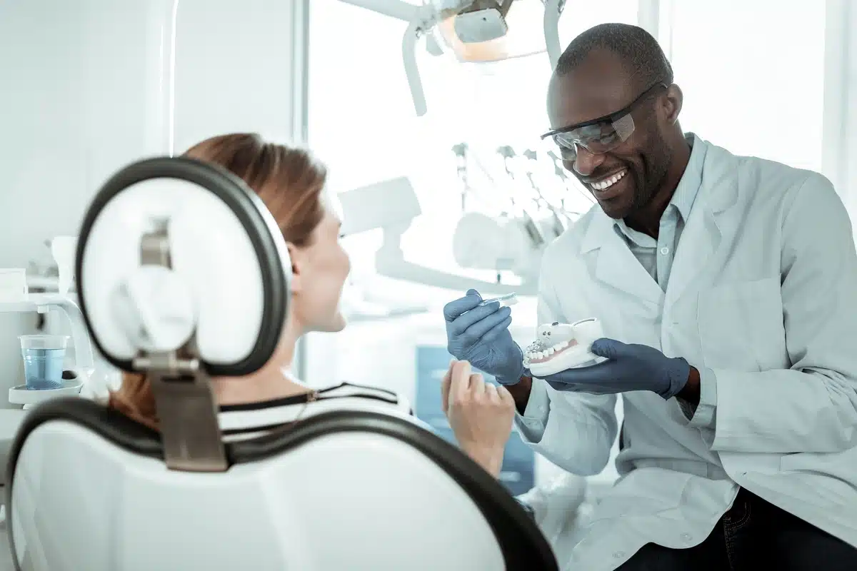 dentist at his clinic talking to the patient