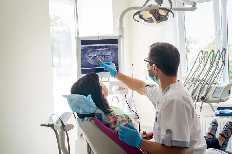 dentist showing patient the results of an x ray