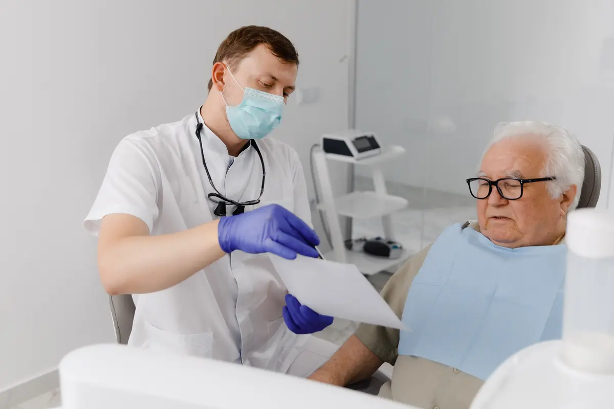 dentist consulting with older man